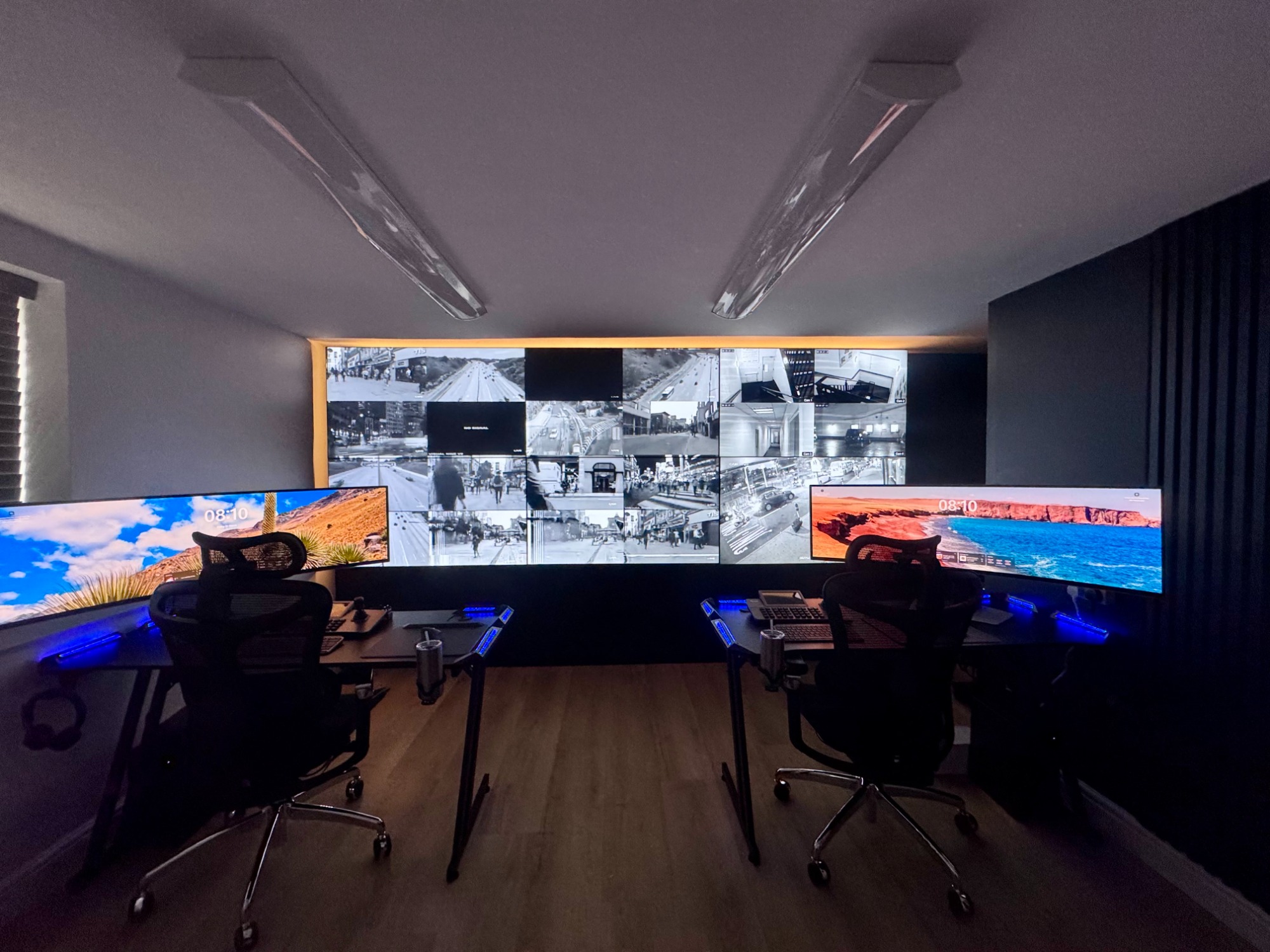 Modern office workspace with dual monitors and ambient lighting.